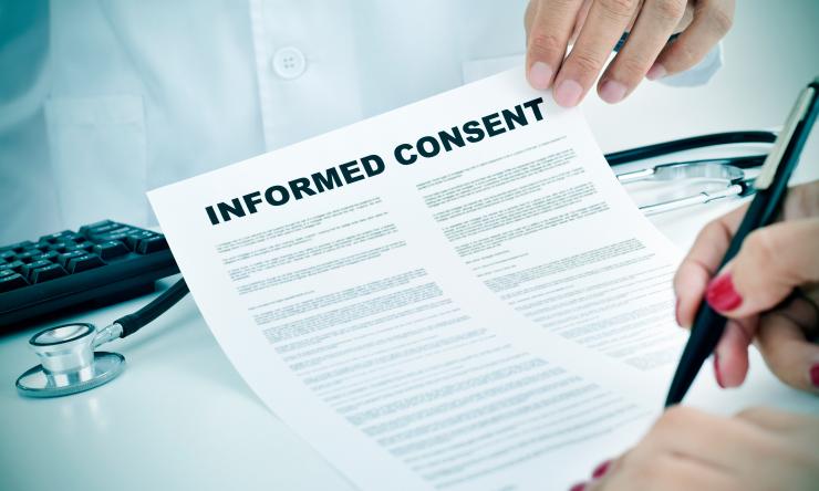 photo of person signing an informed consent letter