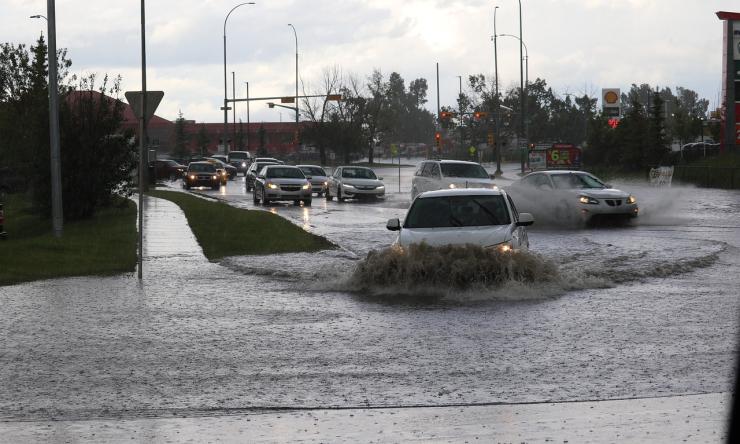 Photo of cars driving through flood water.