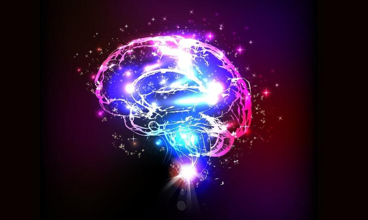 Artists rendition of a brain in pink and blue with what looks like stars inside and outside of the brain to represent activity and memory. 