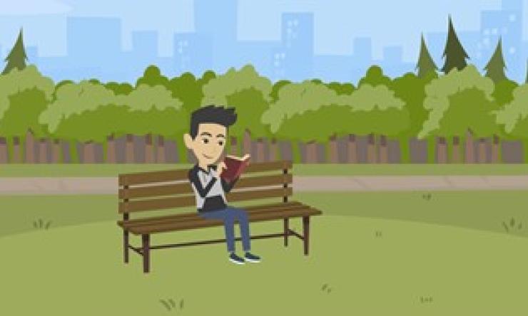 George is sitting on a bench in a park and reading a book. The weather is nice.