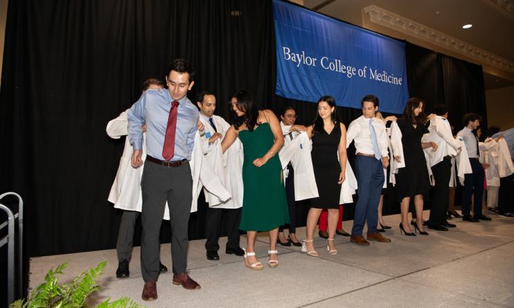 Photo of medical students receiving their white coats.