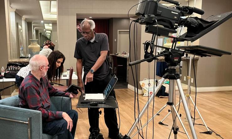 A video team working behind the camera.