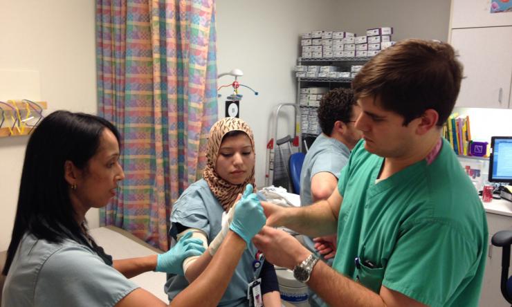 Casting/Splinting Demonstration. Left to right: Vinitha Shenava, M.D. (Assistant Professor), Hibba Aziz, M.D. (PGY-1), Bryce Bell, M.D. (Chief Resident), and Brian Vial, M.D. (PGY-1)