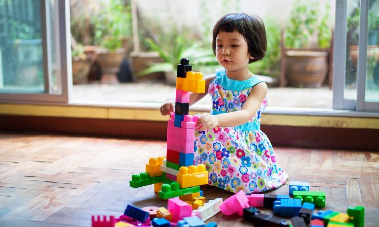 Young girl playing with legos, for SPARK research recruitment