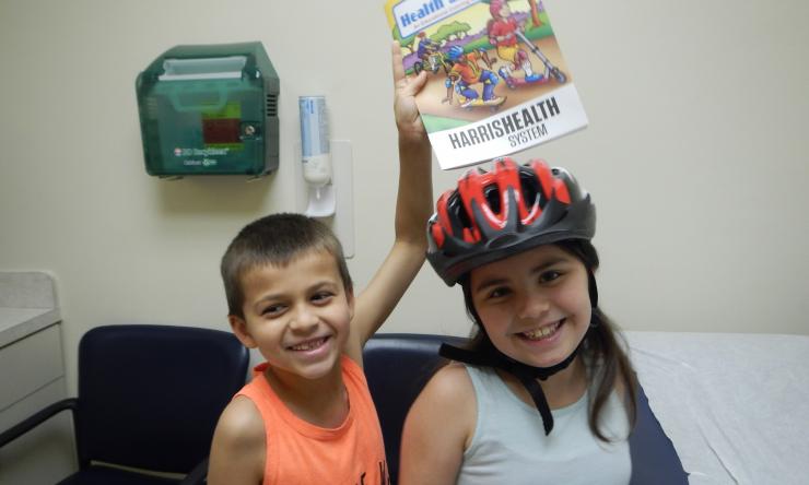 Physicians and residents gave away bicycle helmets, discusses safety during the summer months.