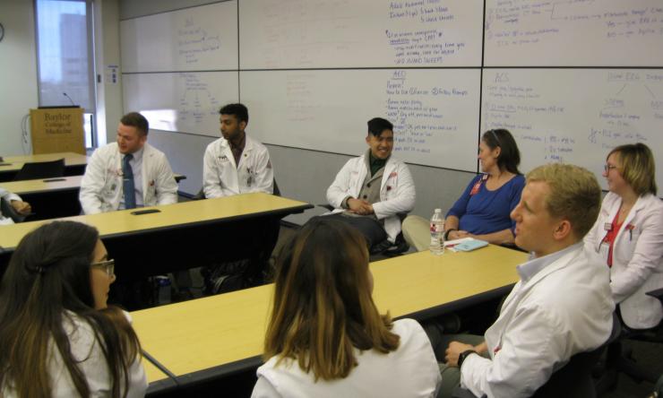 Students debrief with Dr. Hatfield after an interprofessional educational experience.
