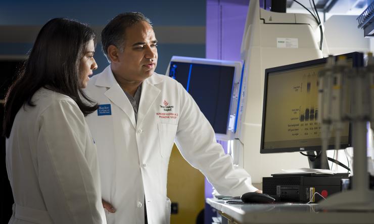 Dr. Sundeep Keswani and colleague reviewing patient files.