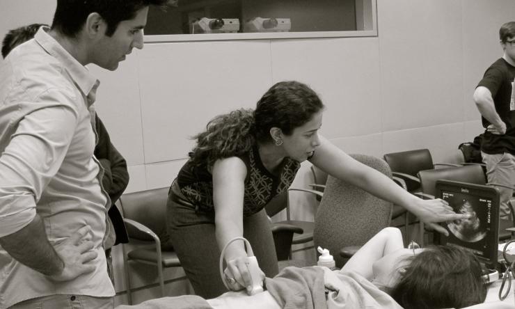 Dr. Rohra teaching Emergency Medicine Residents and Dr. Rohra