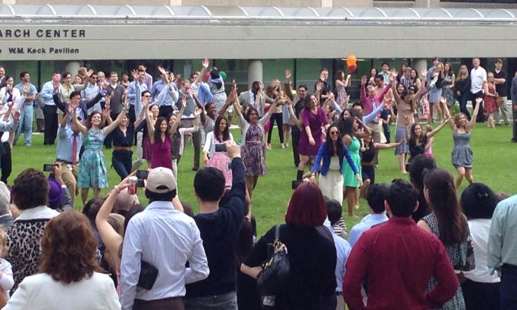 Members from the Class of 2014 dance to Pharrell Williams Happy in a surprise dance mob.